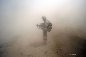 Still photography for documentary film Kandahar Journals. A Canadian soldier holds still as the dust clears after a blast from an Improvised Explosive Device in Kalacha near Nakhonay, Panjwa'i District, Kandahar, Afghanistan. www.kandaharjournals.com (Credit Image: © Louie Palu) For use in film reviews to do with Kandahar Journals only.